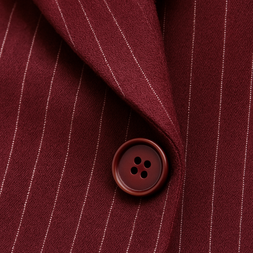 Close-up detail of a bordeaux wool fabric with thin vertical white pinstripes, soft wool texture, matte finish, luxury fashion textile photography, focus on fabric weave and button detail in the same tone as fabric.”