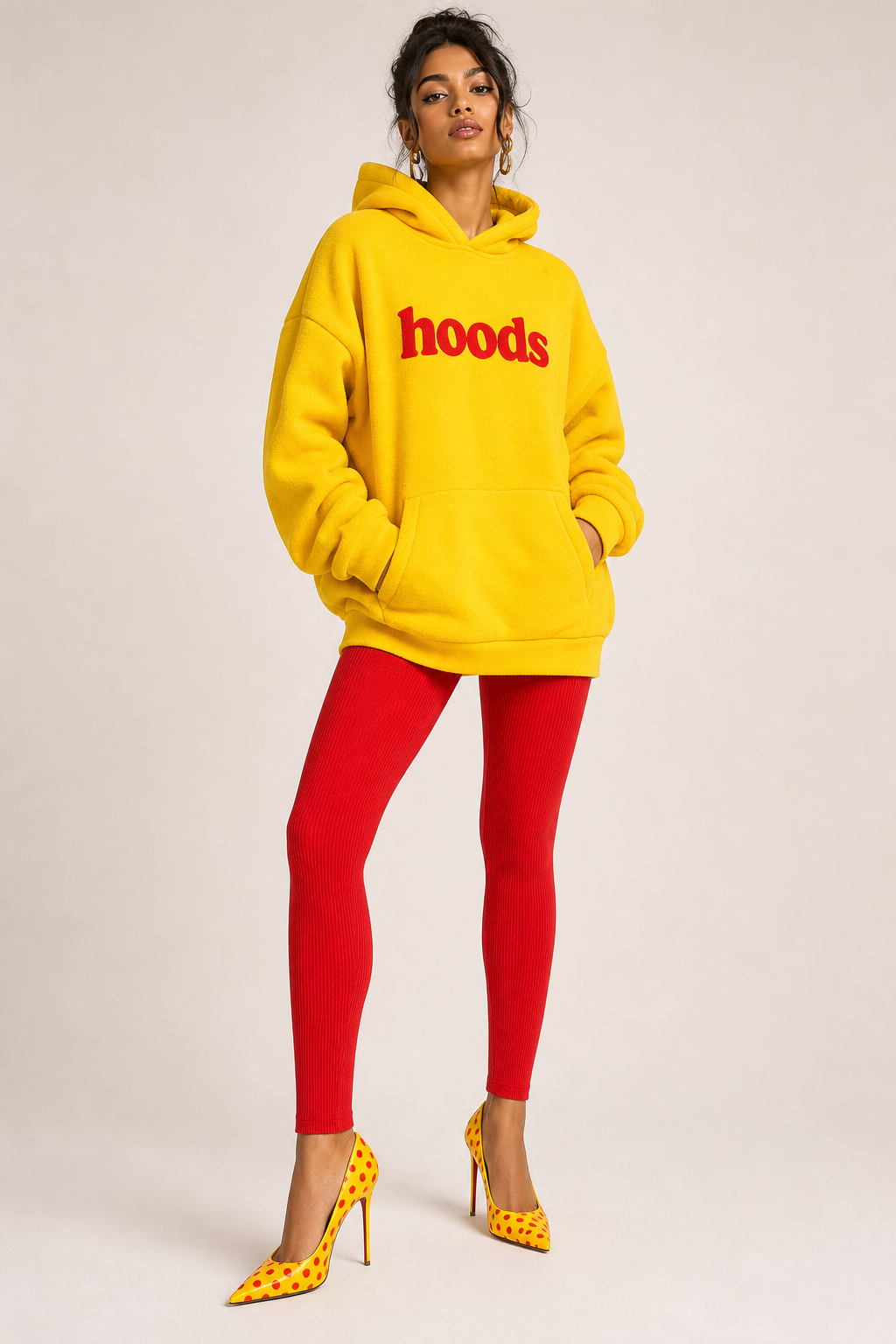 Bright yellow hoodie with red letters saying hoods. Red leggings. Bright yellow high heel with little red pokadots .
Bright yellow fleece hoodie, relaxed fit, with red "hoods" graphic. Red knit leggings. Bright yellow leather high heels, pointed toe, with small red polka dots.