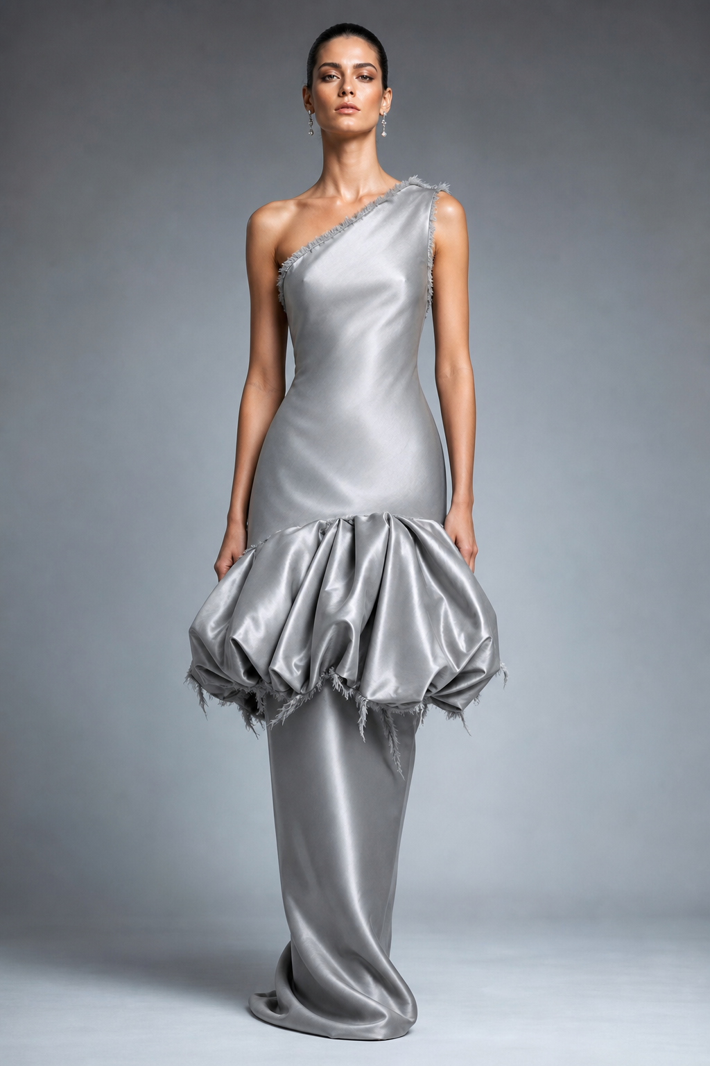 One shoulder tight long silver dress with bubble hem at center of dress and frayed edges on bubble hem and bottom of dress. Frayed edges on top of dress and one shoulder.
Haute Couture fashion design: **Haute Couture Prompt:** One-shoulder column gown in silver silk, precisely tailored. An architectural bubble hem creates volume at the thigh, finished with controlled frayed edges. Subtle fraying defines the neckline and single shoulder strap.