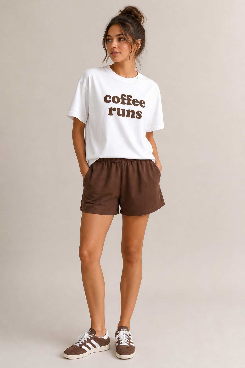 White t-shirt with brown letters saying coffee runs with brown shorts. Brown gym shoe with white pin strips and white laces.
Ready To Wear fashion design: White cotton t-shirt with "coffee runs" in brown. Brown cotton shorts. Brown, low-top gym shoes with white stripes and white laces. Casual fit.